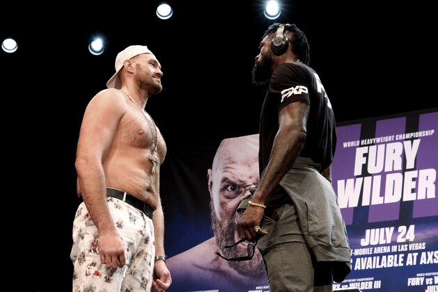 Tyson Fury, left and Deontay Wilder face off at a news conference in Los Angeles on Tuesday, June 15, 2021. The two are scheduled to fight in a heavyweight boxing bout July 24 in Las Vegas. (AP Photo/Richard Vogel)