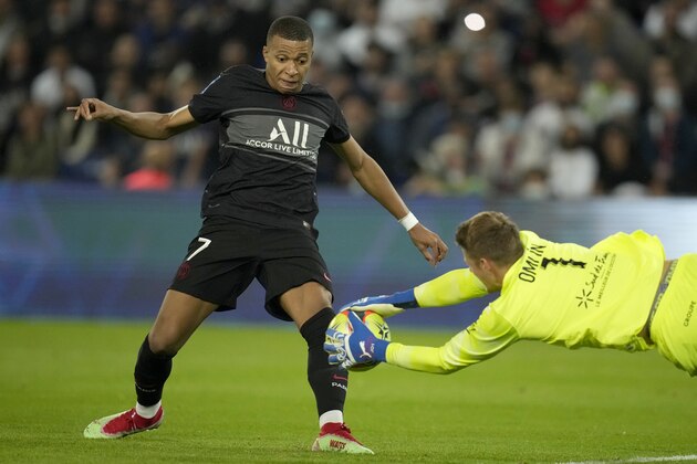 Montpellier's goalkeeper Jonas Omlin dives for a save in front of PSG's Kylian Mbappe, left, during the French League One soccer match between Paris Saint-Germain and Montpellier at the Parc des Princes stadium in Paris, Saturday, Sept. 25, 2021. (AP Photo/Christophe Ena)