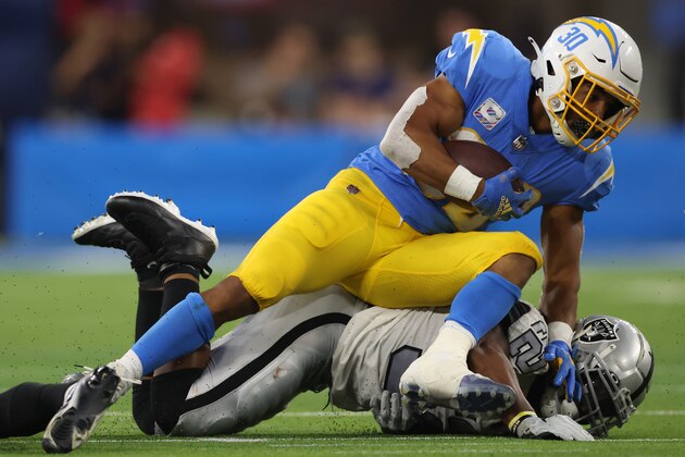 INGLEWOOD, CALIFORNIA - OCTOBER 04: Running back Austin Ekeler #30 of the Los Angeles Chargers is tackled by cornerback Casey Hayward #29 of the Las Vegas Raiders during the second half at SoFi Stadium on October 4, 2021 in Inglewood, California. (Photo by Harry How/Getty Images)