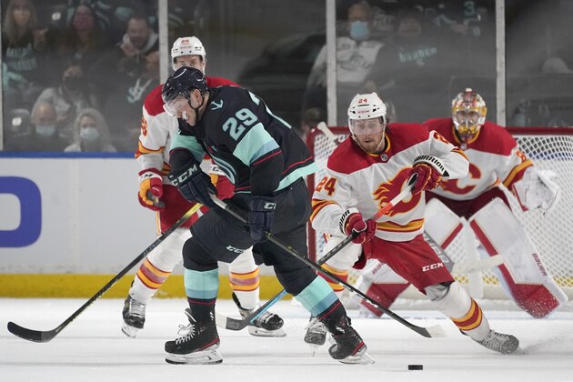 Seattle Kraken defenseman Vince Dunn (29) tries to keep the puck away from Calgary Flames right wing Brett Ritchie (24) during the third period of an NHL preseason hockey game, Saturday, Oct. 2, 2021, in Kent, Wash. The Flames won 4-1. (AP Photo/Ted S. Warren)