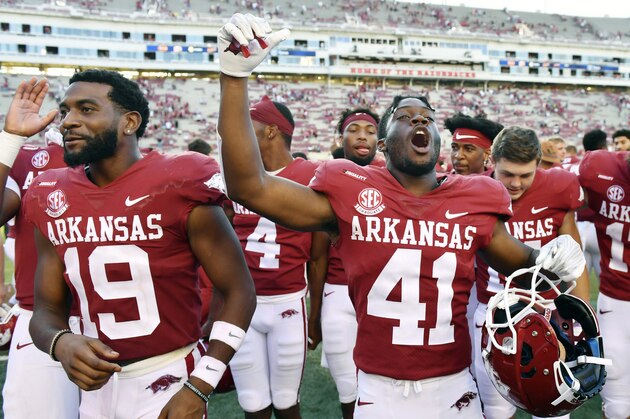 Arkansas players Tyson Morris (19) and T.J. Hammonds (41) celebrate their win over Georgia Southern after an NCAA college football game Saturday, Sept. 18, 2021, in Fayetteville, Ark. (AP Photo/Michael Woods)