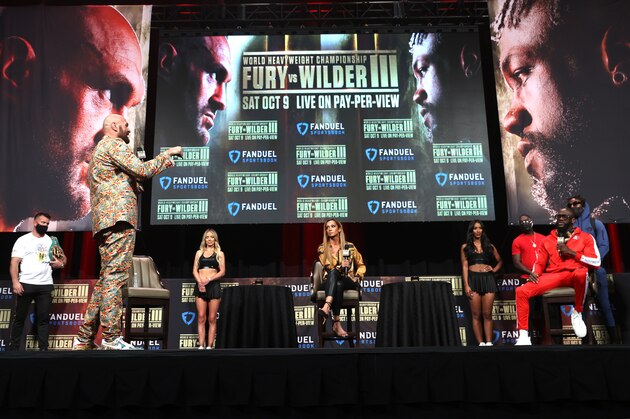 LAS VEGAS, NEVADA - OCTOBER 06: WBC heavyweight champion Tyson Fury (L) and Deontay Wilder (R) exchange words during the press conference at MGM Grand Garden Arena on October 06, 2021 in Las Vegas, Nevada. (Photo by Mikey Williams/Top Rank Inc via Getty Images)