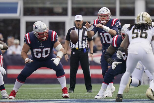 New England Patriots quarterback Mac Jones takes the snap from center David Andrews (60) during the first half of an NFL football game, Sunday, Sept. 26, 2021, in Foxborough, Mass. (AP Photo/Steven Senne)