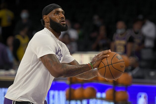 Los Angeles Lakers forward LeBron James (6) warms up before playing the Phoenix Suns in a preseason NBA basketball game in Los Angeles, Sunday, Oct. 10, 2021. (AP Photo/John McCoy)