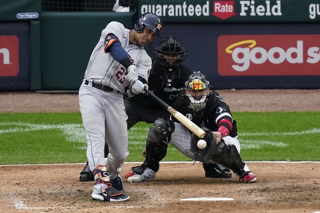Houston Astros' Michael Brantley hits a one-run single against the Chicago White Sox in the sixth inning during Game 4 of a baseball American League Division Series Tuesday, Oct. 12, 2021, in Chicago. (AP Photo/Charles Rex Arbogast)