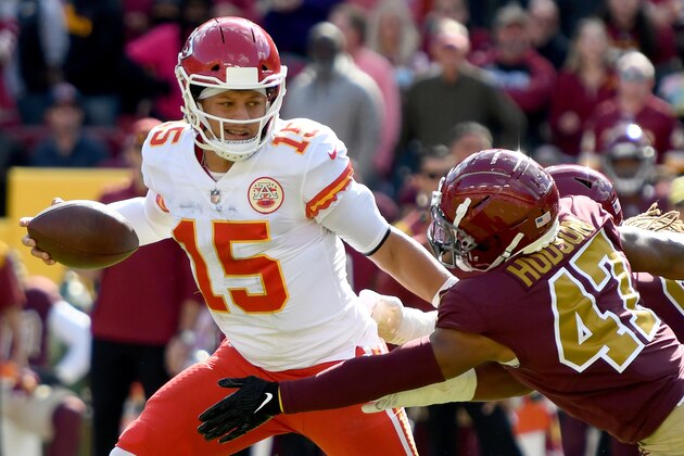 LANDOVER, MARYLAND - OCTOBER 17: Patrick Mahomes #15 of the Kansas City Chiefs runs with the ball against Khaleke Hudson #47 of the Washington Football Team during the first half at FedExField on October 17, 2021 in Landover, Maryland. (Photo by Mitchell Layton/Getty Images)