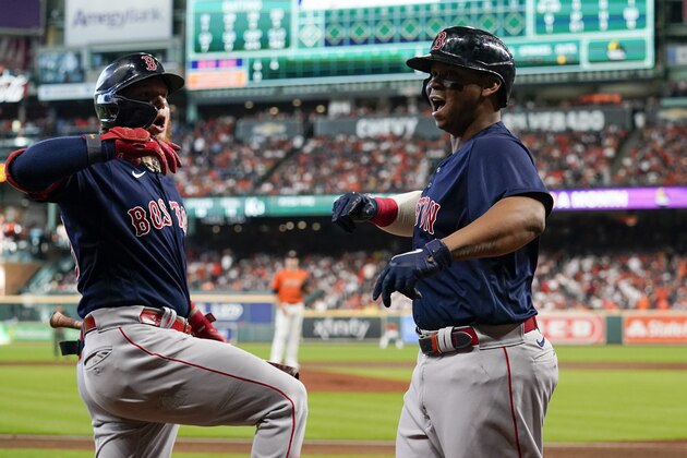 Boston Red Sox's Rafael Devers celebrates a grand slam home run against the Houston Astros during the second inning in Game 2 of baseball's American League Championship Series Saturday, Oct. 16, 2021, in Houston. (AP Photo/Tony Gutierrez)