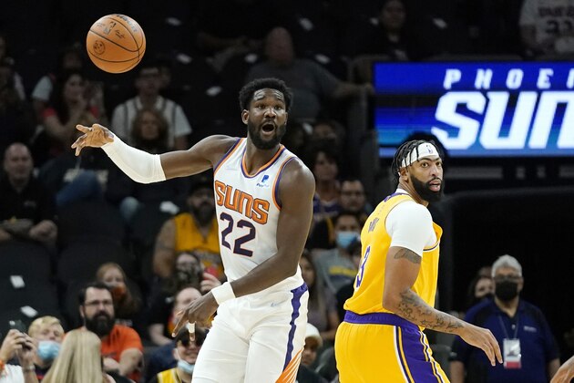 Phoenix Suns center Deandre Ayton (22) passes the ball away from Los Angeles Lakers forward Anthony Davis, right, during the first half of a preseason NBA basketball game Wednesday, Oct. 6, 2021, in Phoenix.(AP Photo/Ross D. Franklin)