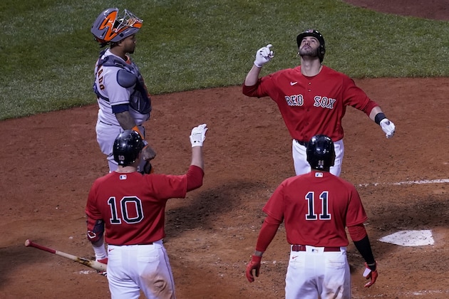 Boston Red Sox's J.D. Martinez celebrates a two-run home run against the Houston Astros during the sixth inning in Game 3 of baseball's American League Championship Series Monday, Oct. 18, 2021, in Boston. (AP Photo/David J. Phillip)