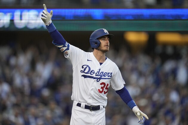 Los Angeles Dodgers center fielder Cody Bellinger reacts after hitting a three-run home run during the eighth inning in Game 3 of baseball's National League Championship Series against the Atlanta Braves Tuesday, Oct. 19, 2021, in Los Angeles. (AP Photo/Ashley Landis)