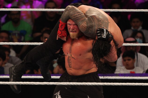 Roman Reigns competes with Brock Lesnar (L) during the World Wrestling Entertainment (WWE) Crown Jewel pay-per-view in the Saudi capital Riyadh on October 21, 2021. (Photo by Fayez Nureldine / AFP) (Photo by FAYEZ NURELDINE/AFP via Getty Images)