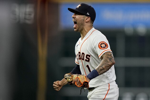 Houston Astros shortstop Carlos Correa celebrates after tagging out Boston Red Sox's Alex Verdugo at second to end the top of the seventh inning in Game 6 of baseball's American League Championship Series Friday, Oct. 22, 2021, in Houston. (AP Photo/David J. Phillip)
