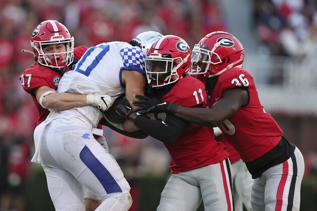 Kentucky wide receiver Chauncey Magwood (10) is stopped by Georgia defensive back Dan Jackson (47), defensive back Derion Kendrick (11), and defensive back Latavious Brini (36) as he carries the ball during the second half of an NCAA college football game Saturday, Oct. 16, 2021 in Athens, Ga. (AP Photo/Butch Dill)