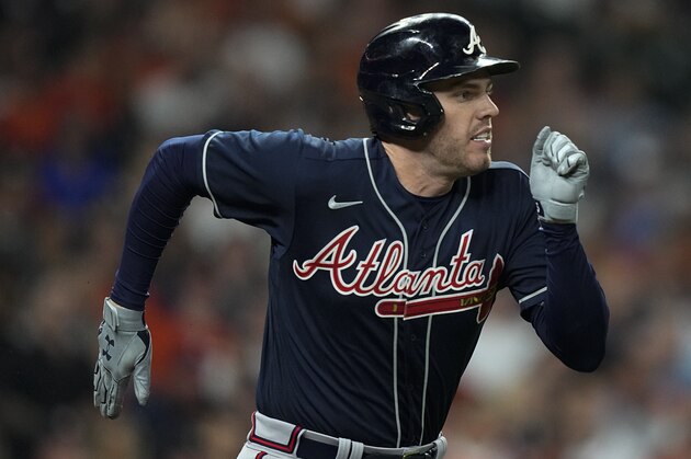 Atlanta Braves' Freddie Freeman runs to first during the first inning of Game 1 in baseball's World Series between the Houston Astros and the Atlanta Braves Tuesday, Oct. 26, 2021, in Houston. (AP Photo/David J. Phillip)