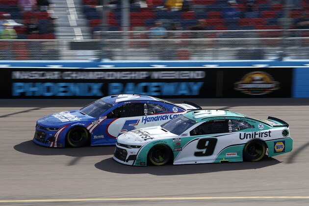Kyle Larson (5) and Chase Elliott (9) race through Turn 4 during a NASCAR Cup Series auto race at Phoenix Raceway, Sunday, March 14, 2021, in Avondale, Ariz. (AP Photo/Ralph Freso)