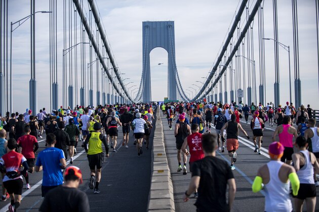 Runners make their way at the start of NYC marathon on Sunday, Nov. 7, 2021, in New York. (AP Photo/Brittainy Newman)