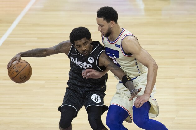 PHILADELPHIA, PA - APRIL 14: Kyrie Irving #11 of the Brooklyn Nets dribbles the ball against Ben Simmons #25 of the Philadelphia 76ers at the Wells Fargo Center on April 14, 2021 in Philadelphia, Pennsylvania. The 76ers defeated the Nets 123-117. NOTE TO USER: User expressly acknowledges and agrees that, by downloading and or using this photograph, User is consenting to the terms and conditions of the Getty Images License Agreement. (Photo by Mitchell Leff/Getty Images)
