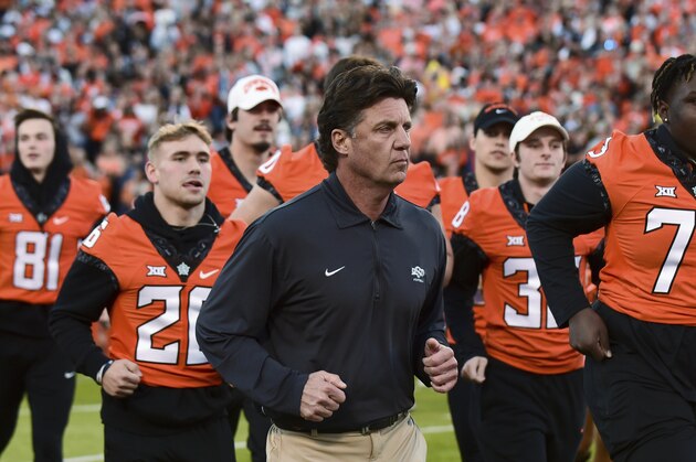 Oklahoma State coach Mike Gundy takes the field for the team's NCAA college football game against Kansas on Saturday, Oct. 30, 2021, in Stillwater, Okla. (AP Photo/Brody Schmidt)