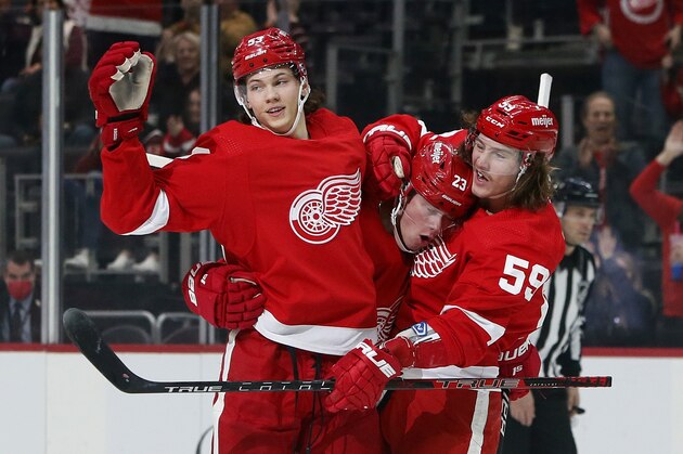 Detroit Red Wings left wing Lucas Raymond (23) celebrates with defenseman Moritz Seider (53) and left wing Tyler Bertuzzi (59) after scoring against the Vegas Golden Knights during the first period of an NHL hockey game Sunday, Nov. 7, 2021, in Detroit. (AP Photo/Duane Burleson)
