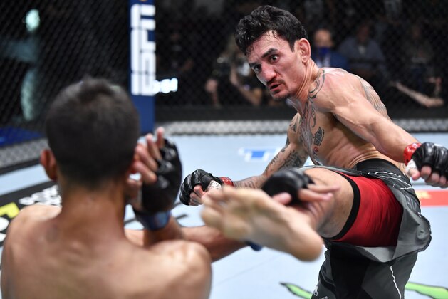 LAS VEGAS, NEVADA - NOVEMBER 13: (R-L) Max Holloway kicks Yair Rodriguez of Mexico in a featherweight fight during the UFC Fight Night event at UFC APEX on November 13, 2021 in Las Vegas, Nevada. (Photo by Chris Unger/Zuffa LLC)