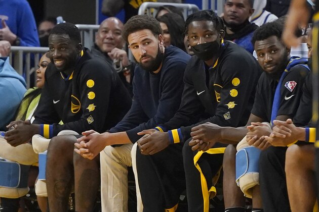 Golden State Warriors' Draymond Green, from left, sits on the bench with Klay Thompson, Jonathan Kuminga and Andrew Wiggins during an NBA basketball game against the New Orleans Pelicans in San Francisco, Friday, Nov. 5, 2021. (AP Photo/Jeff Chiu)