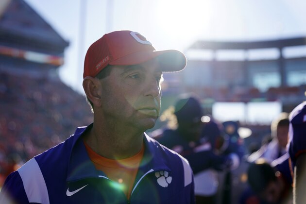 Clemson head coach Dabo Swinney, center, walks on the field after an NCAA college football game against the Connecticut, Saturday, Nov. 13, 2021, in Clemson, S.C. (AP Photo/Brynn Anderson)