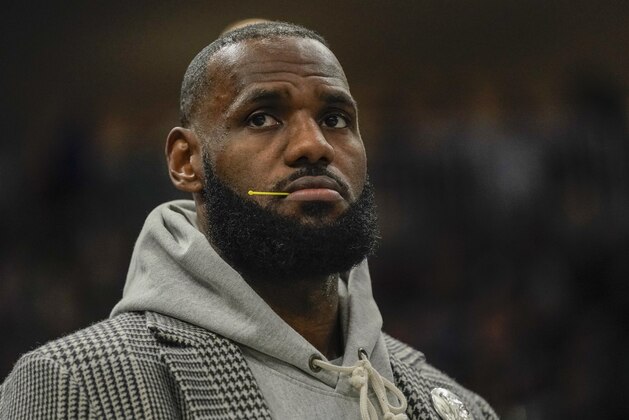 Los Angeles Lakers' LeBron James watches from the bench during the second half of an NBA basketball game against the Milwaukee Bucks Wednesday, Nov. 17, 2021, in Milwaukee. The Bucks won 109-102. (AP Photo/Morry Gash)