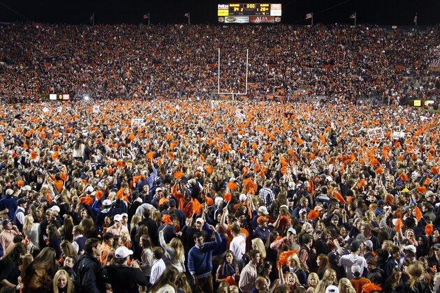 FILE - In this Saturday, Nov. 30, 2013, file photo, Auburn fans storm the field, blanketing it from goal line to goal line with a giddy mass of orange and blue after a win over Alabama during an NCAA college football game in Auburn, Ala. Alabama returns to the scene of Auburn’s Kick-Six on Saturday, Nov. 28, 2015. (AP Photo/Skip Martin, File)
