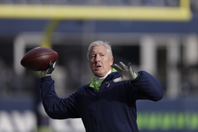 Seattle Seahawks head coach Pete Carroll throws a football before an NFL football game against the Arizona Cardinals, Sunday, Nov. 21, 2021, in Seattle. (AP Photo/John Froschauer)