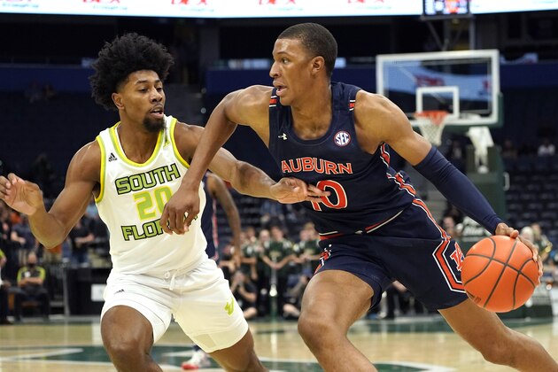 Auburn forward Jabari Smith (10) drives around South Florida forward Sam Hines Jr. (20) during the first half of an NCAA college basketball game Friday, Nov. 19, 2021, in Tampa, Fla. (AP Photo/Chris O'Meara)