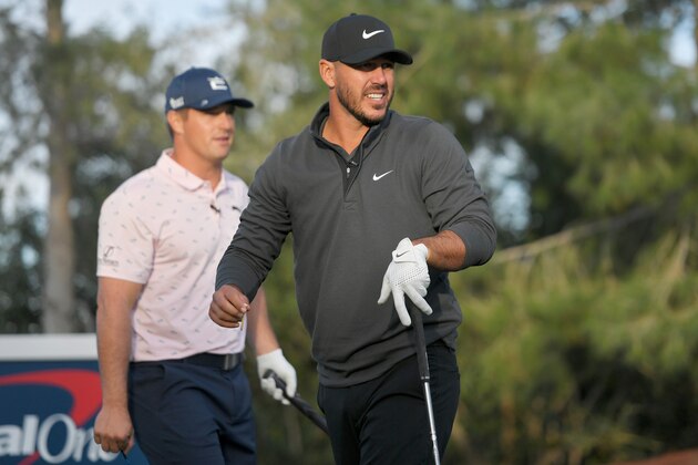 LAS VEGAS, NEVADA - NOVEMBER 26: Brooks Koepka plays his shot from the 10th tee as Bryson DeChambeau looks on during Capital One's The Match V: Bryson v Brooks at Wynn Golf Course on November 26, 2021 in Las Vegas, Nevada. (Photo by David Becker/Getty Images for The Match)