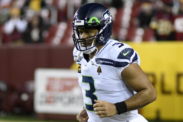 Seattle Seahawks quarterback Russell Wilson runs onto the field prior to an NFL football game against the Washington Football Team, Monday, Nov. 29, 2021, in Landover, Md. (AP Photo/Mark Tenally)