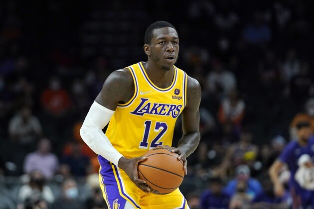 Los Angeles Lakers guard Kendrick Nunn looks to pass the ball against the Phoenix Suns during the first half of a preseason NBA basketball game Wednesday, Oct. 6, 2021, in Phoenix.(AP Photo/Ross D. Franklin)