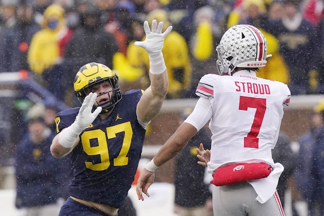 Michigan defensive end Aidan Hutchinson (97) rushes Ohio State quarterback C.J. Stroud (7) during the first half of an NCAA college football game, Saturday, Nov. 27, 2021, in Ann Arbor, Mich. (AP Photo/Carlos Osorio)