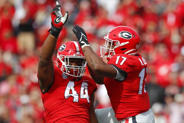 ATHENS, GA - NOVEMBER 06: Travon Walker #44 of the Georgia Bulldogs reacts after a sack with Nakobe Dean #17 in the second half against the Missouri Tigers at Sanford Stadium on November 6, 2021 in Athens, Georgia. (Photo by Todd Kirkland/Getty Images)