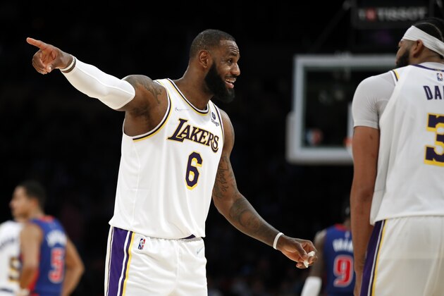 Los Angeles Lakers forwards LeBron James, left, gestures with Anthony Davis during the second half of an NBA basketball game against the Detroit Pistons Sunday, Nov. 28, 2021, in Los Angeles. (AP Photo/Alex Gallardo)