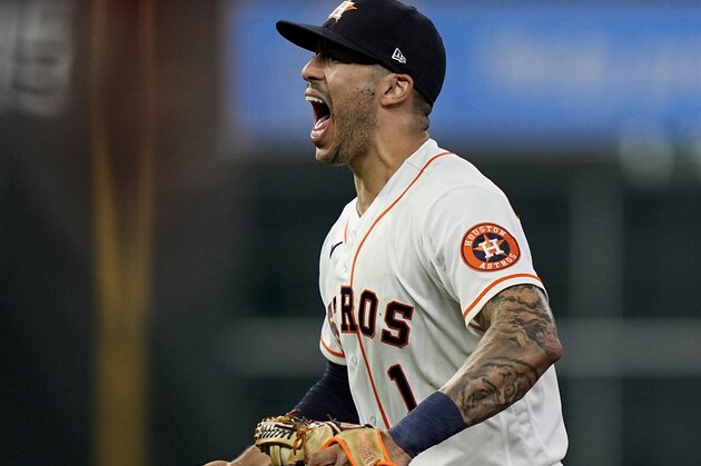Houston Astros shortstop Carlos Correa celebrates after tagging out Boston Red Sox's Alex Verdugo at second to end the top of the seventh inning in Game 6 of baseball's American League Championship Series Friday, Oct. 22, 2021, in Houston. (AP Photo/David J. Phillip)