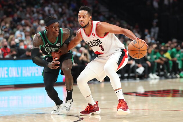 PORTLAND, OREGON - DECEMBER 04: CJ McCollum #3 of the Portland Trail Blazers controls the ball against Dennis Schroder #71 of the Boston Celtics during the third quarter at Moda Center on December 04, 2021 in Portland, Oregon. NOTE TO USER: User expressly acknowledges and agrees that, by downloading and or using this photograph, User is consenting to the terms and conditions of the Getty Images License Agreement. (Photo by Abbie Parr/Getty Images)