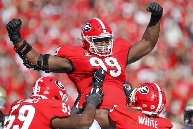 ATHENS, GA - NOVEMBER 20: Jordan Davis #99 of the Georgia Bulldogs reacts after rushing in for a touchdown during the first half against the Charleston Southern Buccaneers at Sanford Stadium on November 20, 2021 in Athens, Georgia. (Photo by Todd Kirkland/Getty Images)