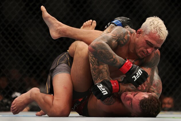 LAS VEGAS, NEVADA - DECEMBER 11: Charles Oliveira (top) of Brazil grapples with Dustin Poirier in their lightweight title fight during the UFC 269 event at T-Mobile Arena on December 11, 2021 in Las Vegas, Nevada. (Photo by Carmen Mandato/Getty Images)