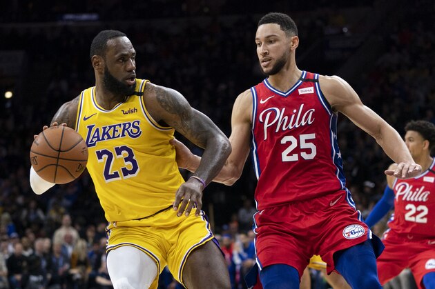 Los Angeles Lakers' LeBron James, left, in action against Philadelphia 76ers' Ben Simmons, right, during the first half of an NBA basketball game, Saturday, Jan. 25, 2020, in Philadelphia. The 76ers won 108-91. (AP Photo/Chris Szagola)