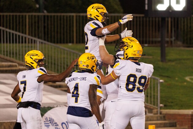 ATHENS, OH - NOVEMBER 16: Toledo Rockets running back Bryant Koback (22) celebrates a touchdown with teammates Toledo Rockets quarterback Dequan Finn (7), Toledo Rockets wide receiver Danzel McKinley-Lewis (4) and Toledo Rockets tight end Drew Rosi (89) during a Mid-American Conference game between the Toledo Rockets and the Ohio Bobcats on November 16, 2021 at Peden Stadium in Athens, Ohio. (Photo by Graham Stokes/Icon Sportswire via Getty Images)