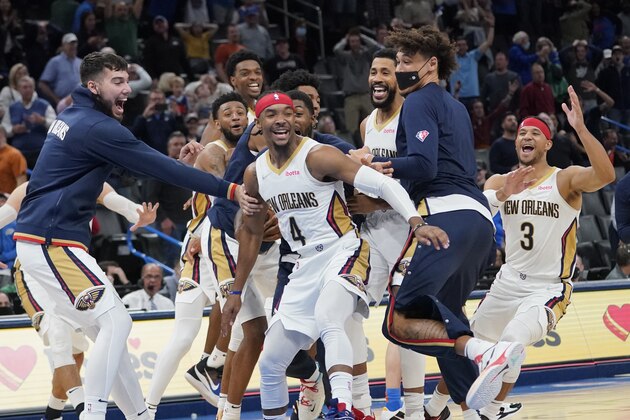 New Orleans Pelicans guard Devonte' Graham (4) celebrates with teammates after hitting the game winning basket to end the second half of an NBA basketball game against the Oklahoma City Thunder, Wednesday, Dec. 15, 2021, in Oklahoma City. (AP Photo/Sue Ogrocki)