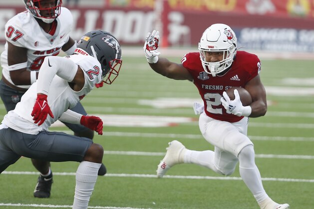 Fresno State running back Ronnie Rivers tries to get past New Mexico cornerback Tony Collier, far left, gives chase during the first half of an NCAA college football game in Fresno, Calif., Saturday, Nov. 13, 2021. (AP Photo/Gary Kazanjian)