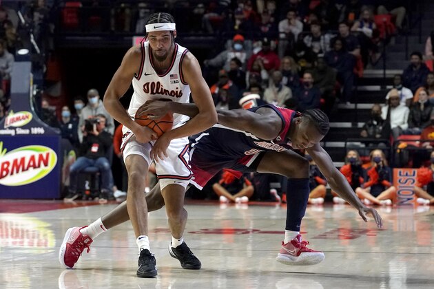 Arizona's Bennedict Mathurin, right, keeps his hand on the ball to get a jump ball call with Illinois' Jacob Grandison during the first half of an NCAA college basketball game Saturday, Dec. 11, 2021, in Champaign, Ill. (AP Photo/Charles Rex Arbogast)