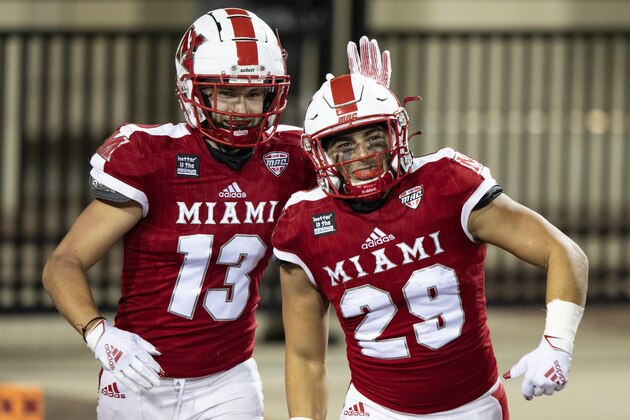 Miami (Oh) Redhawks running back Zach Kahn (29) and wide receiver Jack Sorenson (13) celebrate a touchdown during an NCAA football game against the Ball State Cardinals on Wednesday, Nov. 4, 2020 in Oxford, Ohio. (AP Photo/Emilee Chinn)