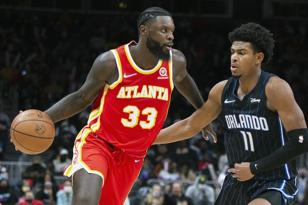 Orlando Magic forward Aleem Ford (11) defends Atlanta Hawks forward Lance Stephenson (33) during the second half of an NBA basketball game Wednesday, Dec. 22, 2021, in Atlanta. (AP Photo/Hakim Wright Sr.)