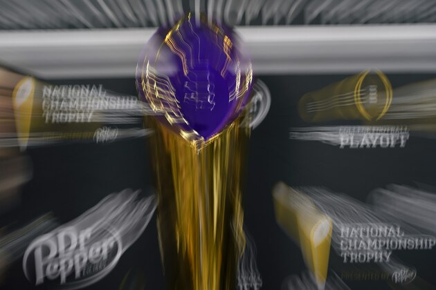 In this picture made with a slow shutter speed shows the championship trophy during media day for NCAA College Football Playoff national championship game Saturday, Jan. 11, 2020, in New Orleans. Clemson is scheduled to play LSU on Monday. (AP Photo/David J. Phillip).