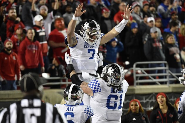 Kentucky quarterback Will Levis (7) is held up by teammate guard Austin Dotson (61) after scoring a touchdown during the first half of an NCAA college football game against Louisville in Louisville, Ky., Saturday, Nov. 27, 2021. (AP Photo/Timothy D. Easley)