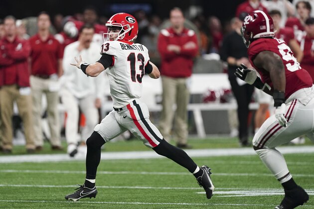 Georgia quarterback Stetson Bennett (13) works against Alabama during the second half of the Southeastern Conference championship NCAA college football game, Saturday, Dec. 4, 2021, in Atlanta. (AP Photo/John Bazemore)